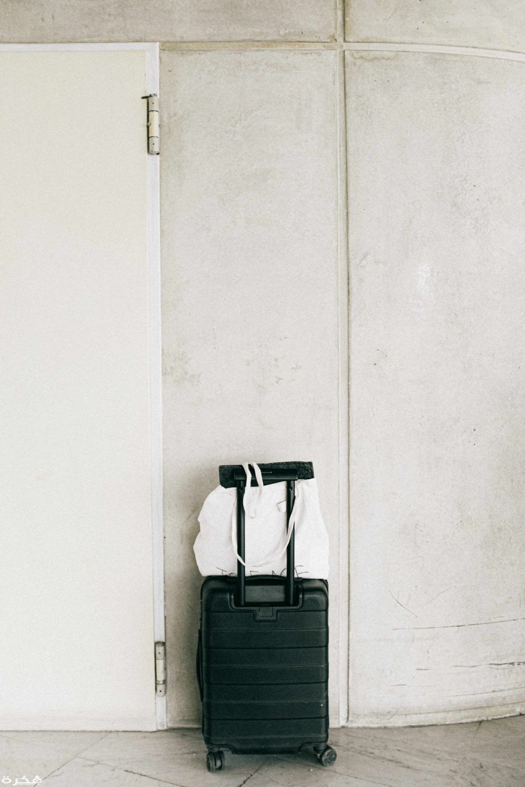 black luggage bag beside door 3277930 scaled