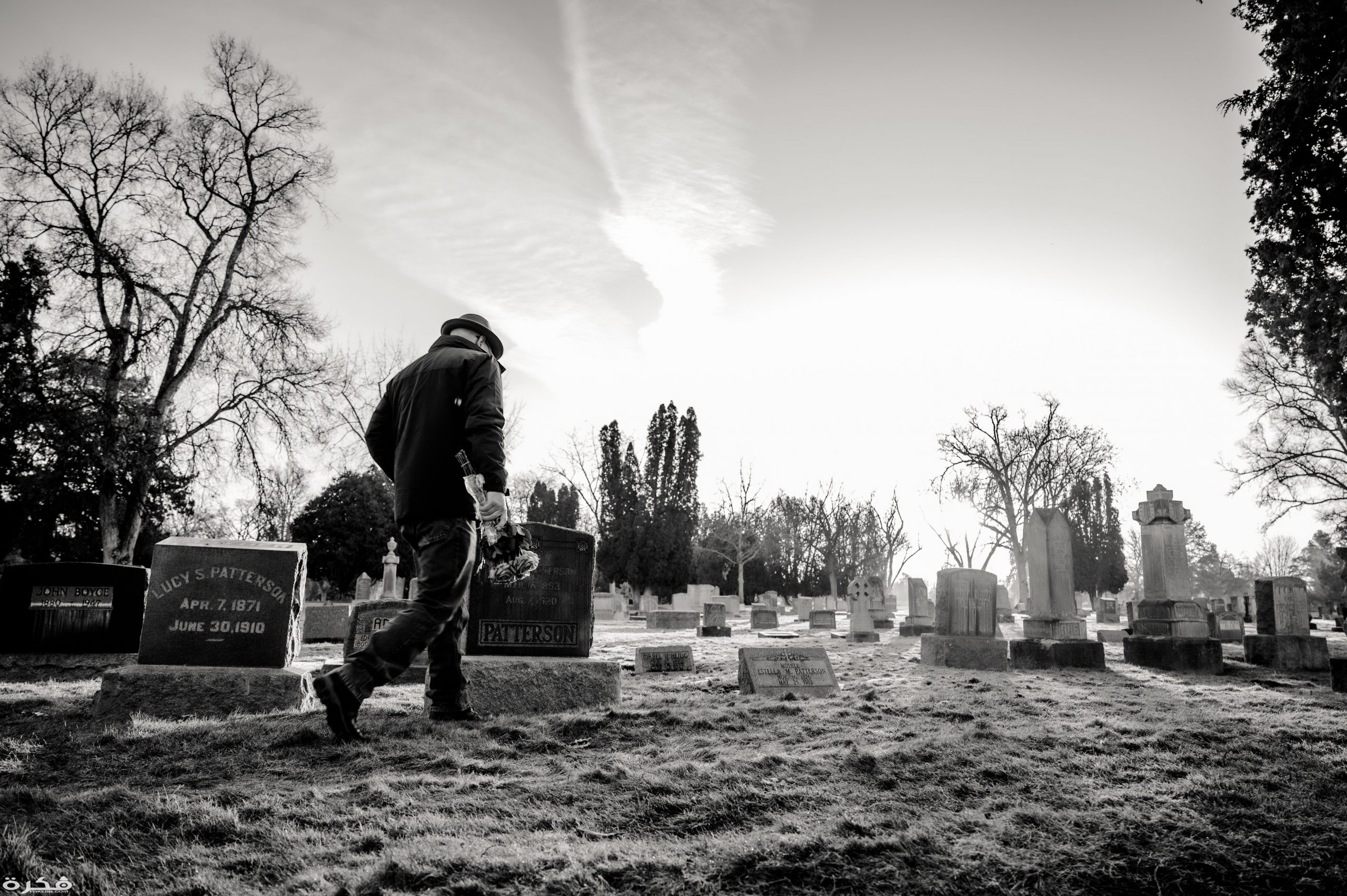 monochrome photo of man walking in cemetery 3648307 scaled