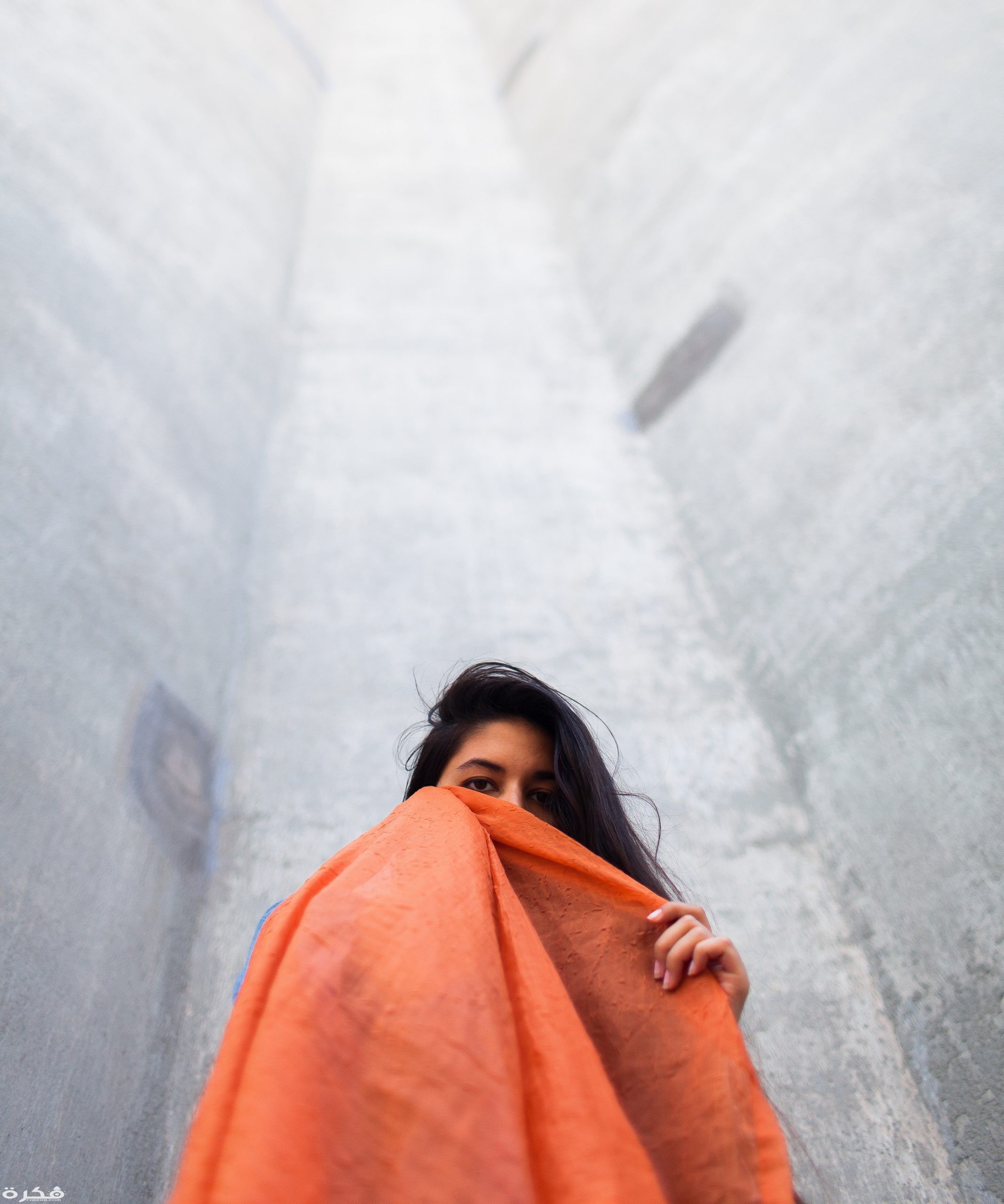woman holding orange scarf 3212783 scaled
